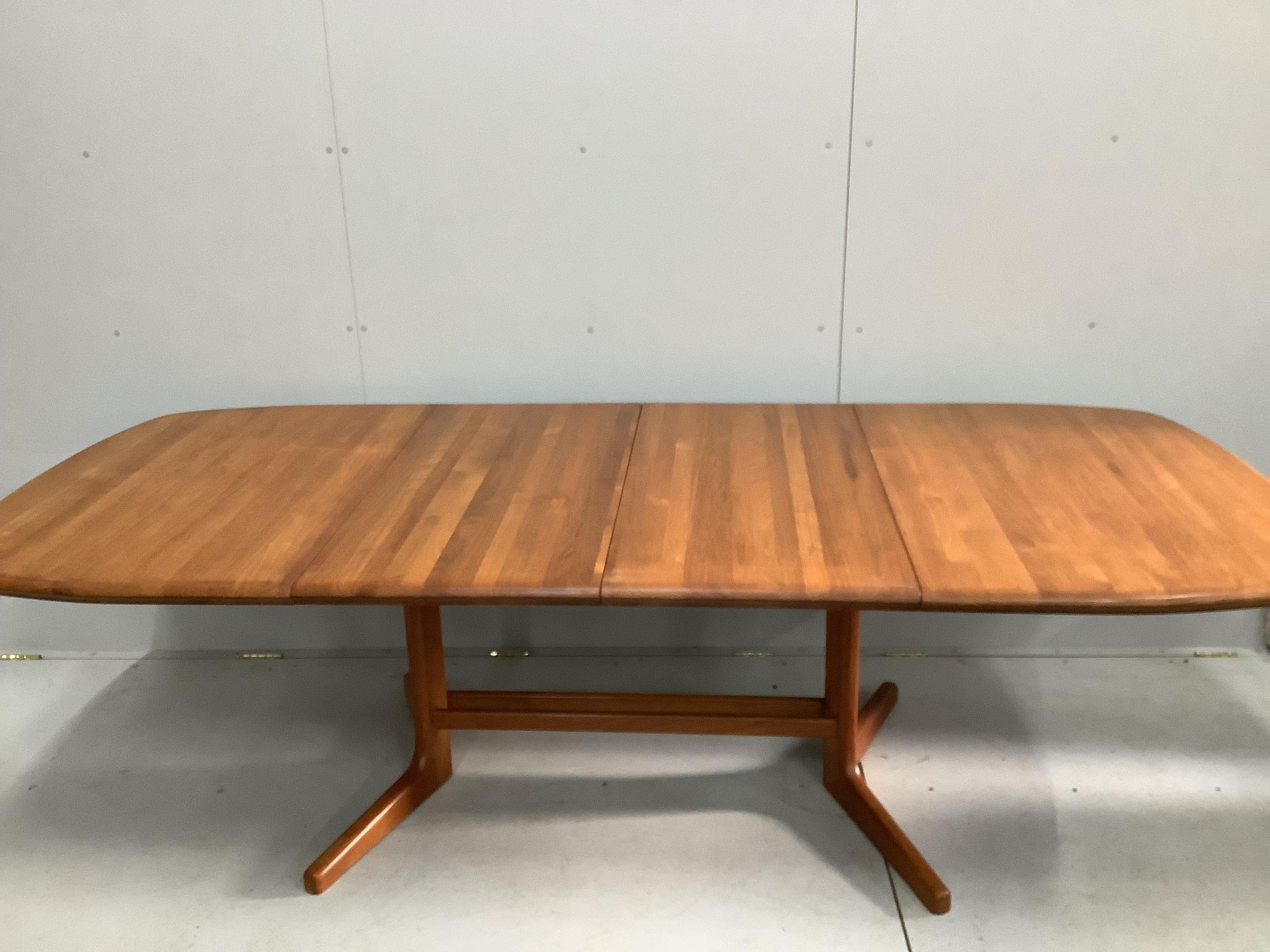 A mid century teak extending dining table, length 150cm, width 106cm, height 74cm and six chairs, two with arms